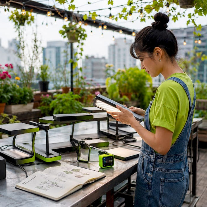 Gardener arranging micro grow light kits on balcony table
