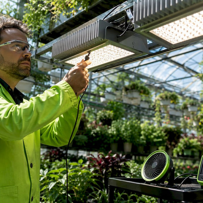 Technician measuring temperature on LED grow light heatsink
